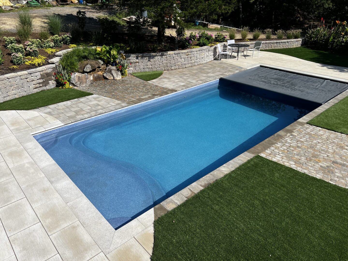 A Rectangular Shaped Pool With a Retractable Cover